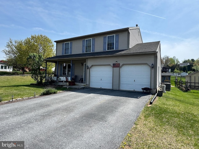 view of front of property featuring a porch, a front lawn, and aphalt driveway