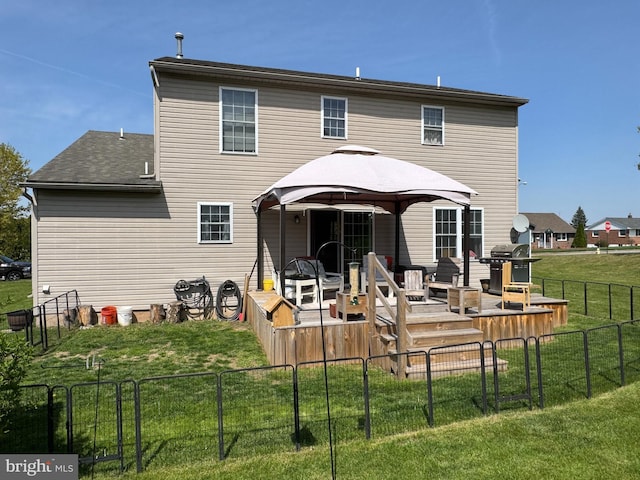 back of house with a lawn, a gazebo, a fenced backyard, and a deck