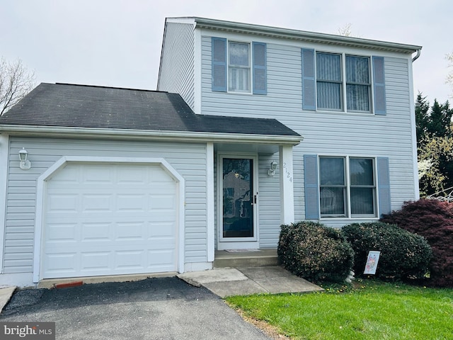 view of front of house with an attached garage and aphalt driveway