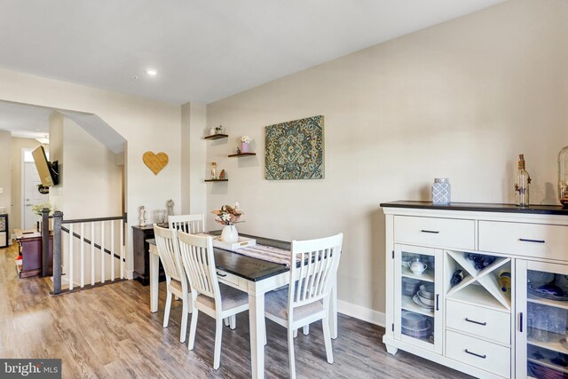dining area with baseboards, recessed lighting, and light wood finished floors