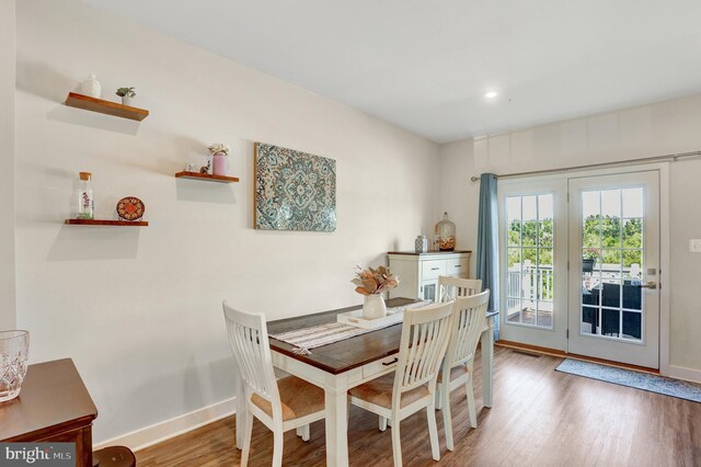 dining area featuring baseboards and wood finished floors