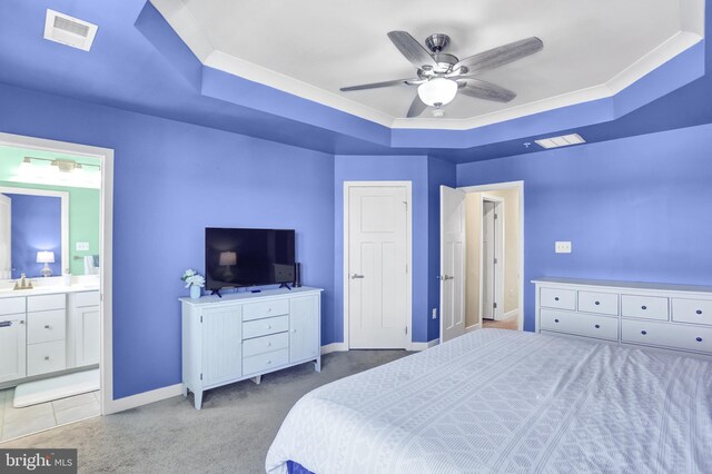 bedroom with light colored carpet, baseboards, visible vents, and a raised ceiling