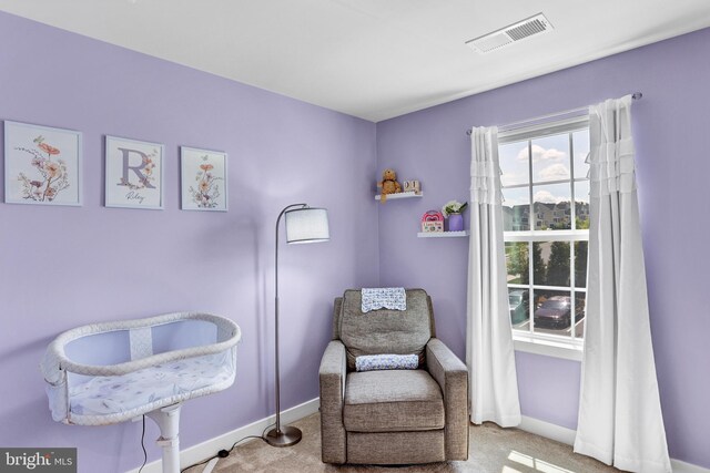 sitting room with visible vents, carpet, and baseboards