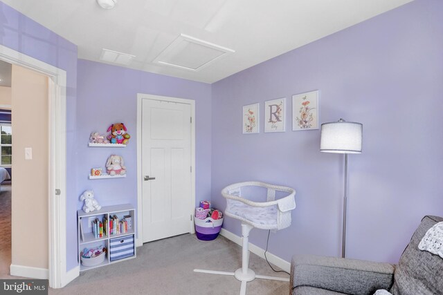 playroom with carpet floors, baseboards, and attic access