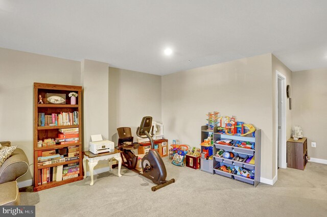recreation room featuring carpet floors and baseboards