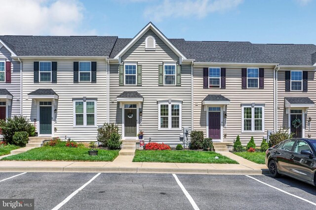townhome / multi-family property with entry steps and uncovered parking
