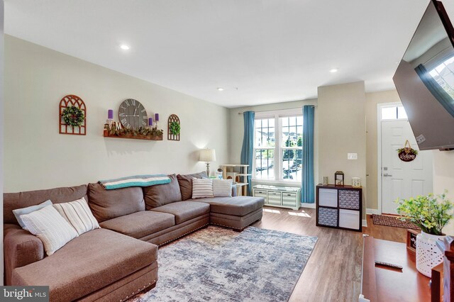 living room with recessed lighting, baseboards, wood finished floors, and a wealth of natural light