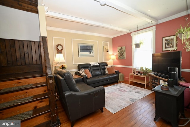 living area with ornamental molding, beam ceiling, and hardwood / wood-style floors