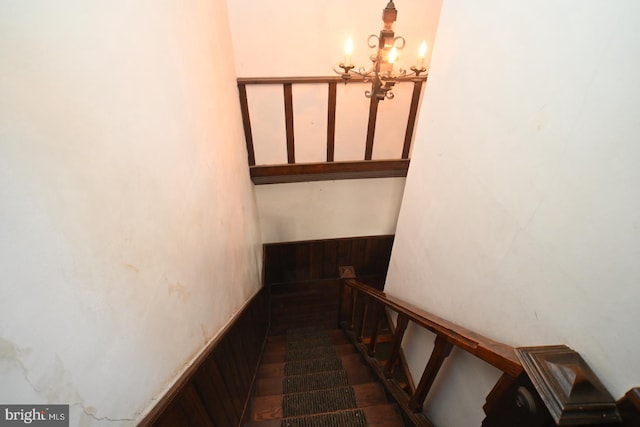 staircase featuring an inviting chandelier