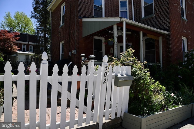 view of side of property with brick siding and fence