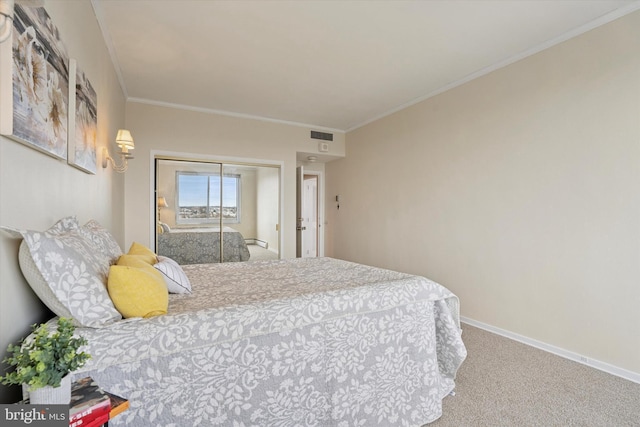 bedroom with visible vents, crown molding, carpet floors, baseboards, and a closet