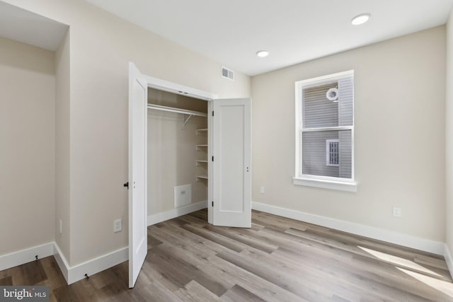1016 Rhode Island Ave NE Unit 1, Washington, DC 20018 - unfurnished bedroom with visible vents, a closet, baseboards, recessed lighting, and wood finished floors