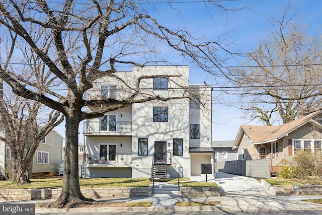 1016 Rhode Island Ave NE Unit 1, Washington, DC 20018 - view of front of property featuring driveway, stucco siding, and a balcony