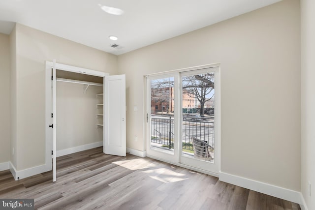 1016 Rhode Island Ave NE Unit 1, Washington, DC 20018 - unfurnished bedroom featuring wood finished floors, visible vents, access to exterior, and baseboards