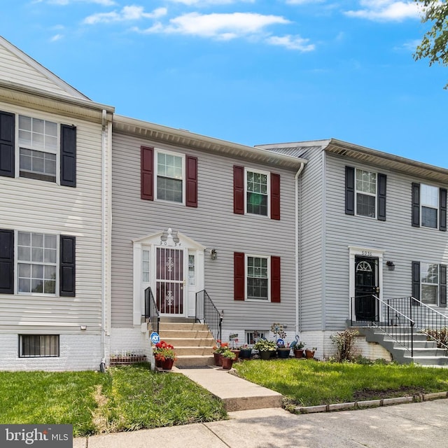 5054 Kenilworth Ave, Hyattsville, MD 20781 - townhome / multi-family property featuring entry steps and a front yard
