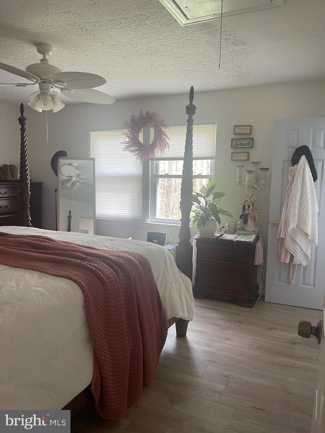 8807 Doug Dr, Nokesville, VA 20181 - bedroom with a textured ceiling, multiple windows, wood finished floors, and attic access