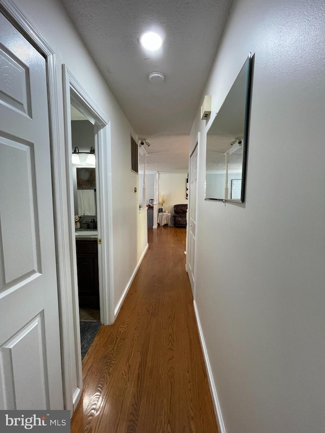 8807 Doug Dr, Nokesville, VA 20181 - hallway with baseboards, wood finished floors, and visible vents