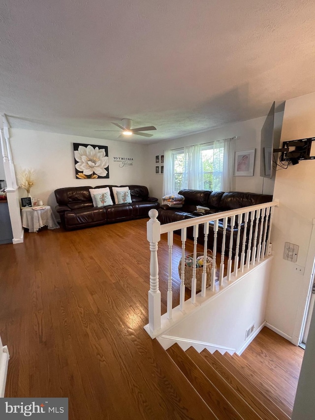 8807 Doug Dr, Nokesville, VA 20181 - stairway with a textured ceiling, ceiling fan, and wood finished floors