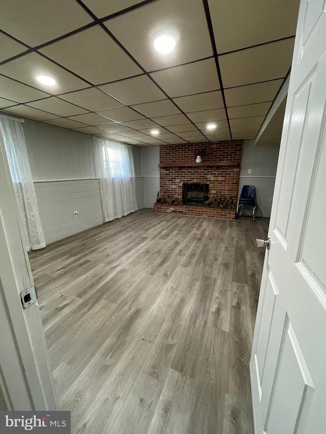 8807 Doug Dr, Nokesville, VA 20181 - below grade area featuring a brick fireplace, wood finished floors, and a paneled ceiling
