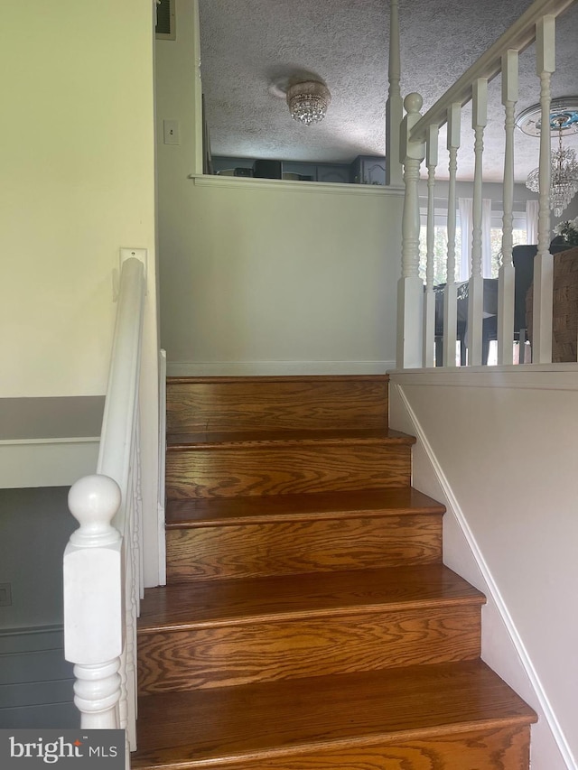 8807 Doug Dr, Nokesville, VA 20181 - staircase with a textured ceiling