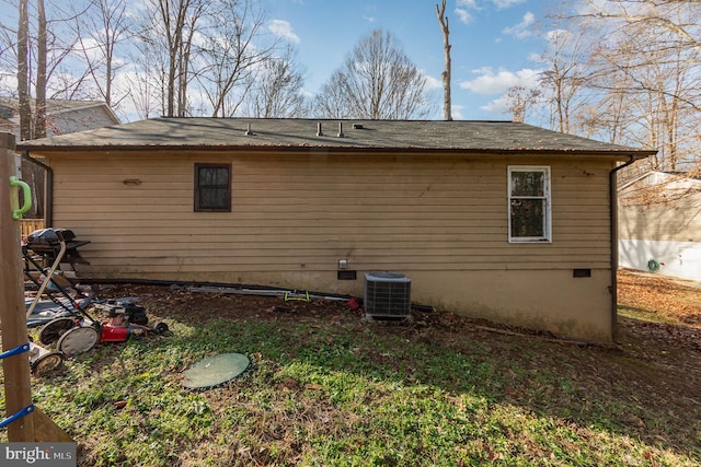 back of property with central AC and crawl space