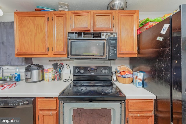 kitchen featuring light countertops and black appliances
