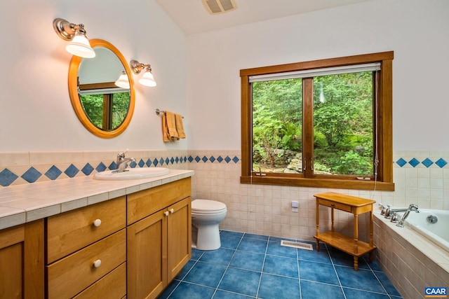 4547 Taylor Creek Rd, Afton, VA 22920 - bathroom with tile patterned flooring, tile walls, a wainscoted wall, toilet, and visible vents