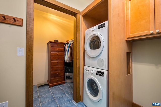 4547 Taylor Creek Rd, Afton, VA 22920 - clothes washing area featuring stacked washer and clothes dryer, dark tile patterned floors, and laundry area