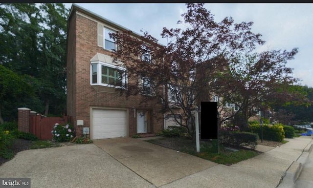 10941 Pebble Run Dr, Silver Spring, MD 20902 - view of front of property with brick siding, an attached garage, and concrete driveway