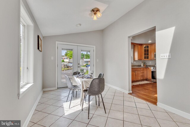 7540 Park Ln, Annandale, VA 22003 - dining room with french doors, lofted ceiling, light tile patterned floors, and baseboards