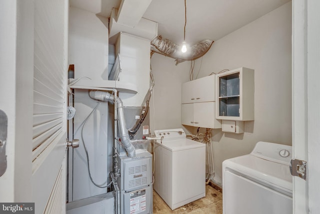 clothes washing area with washing machine and dryer