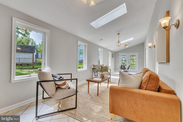 7540 Park Ln, Annandale, VA 22003 - living area featuring vaulted ceiling, a skylight, light tile patterned flooring, and baseboards