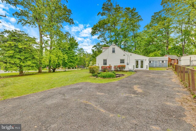 view of side of property with french doors and driveway
