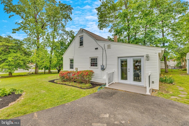 7540 Park Ln, Annandale, VA 22003 - rear view of house with french doors and a lawn