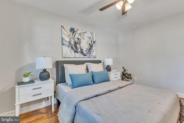 bedroom featuring wood finished floors, ceiling fan, and baseboards
