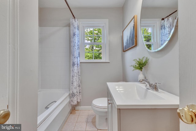 bathroom with tile patterned flooring, toilet, vanity, shower / tub combo, and baseboards