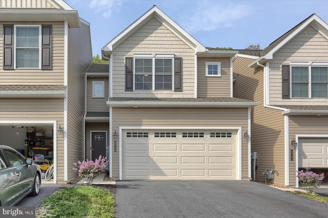 view of property featuring an attached garage and driveway