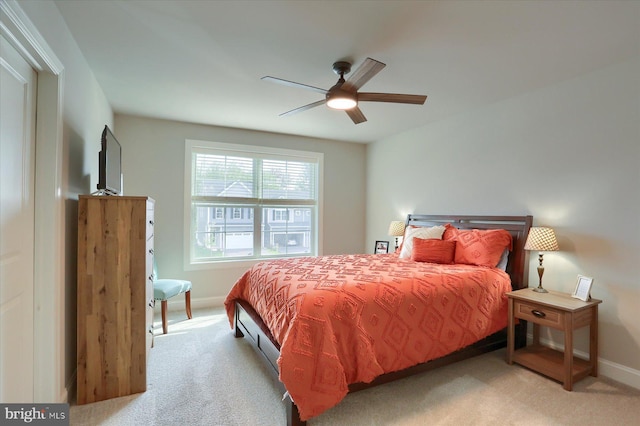 carpeted bedroom featuring baseboards and a ceiling fan