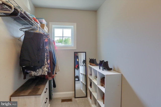 spacious closet featuring visible vents and light carpet