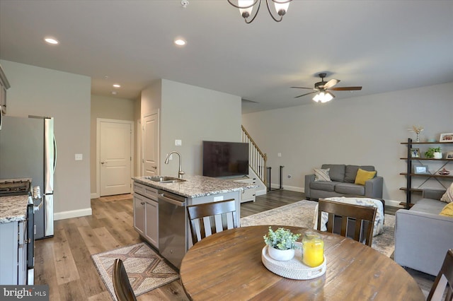 dining space with a ceiling fan, stairway, baseboards, light wood finished floors, and recessed lighting