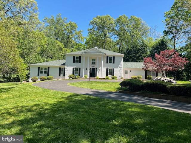 2407 Mare Ln, Oakton, VA 22124 - greek revival inspired property featuring a front yard and stucco siding