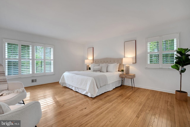 2407 Mare Ln, Oakton, VA 22124 - bedroom featuring multiple windows, light wood-style floors, and baseboards