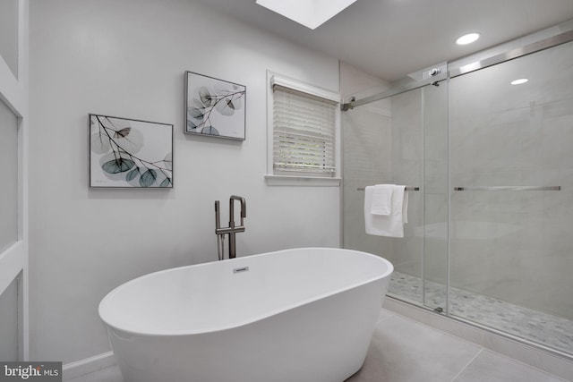 2407 Mare Ln, Oakton, VA 22124 - full bath with a freestanding tub, a stall shower, tile patterned floors, recessed lighting, and a skylight