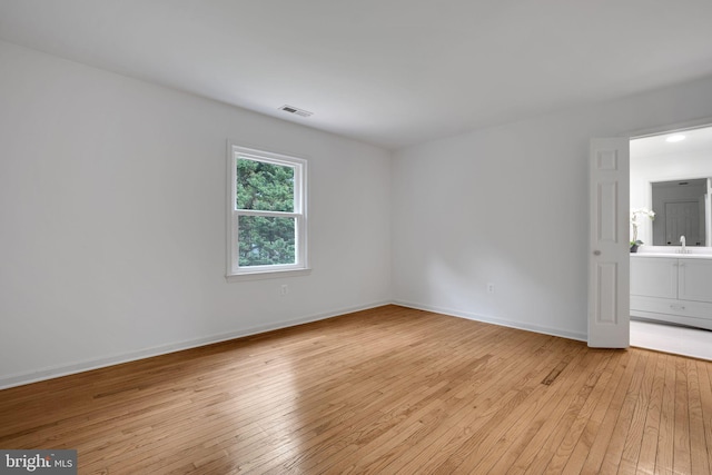 2407 Mare Ln, Oakton, VA 22124 - unfurnished room with light wood finished floors, baseboards, and a sink