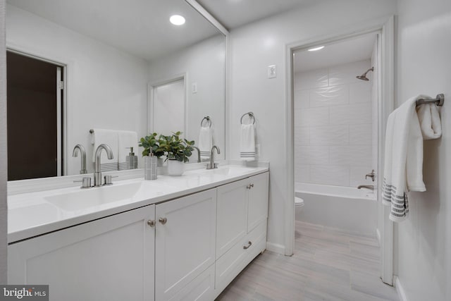 2407 Mare Ln, Oakton, VA 22124 - bathroom with double vanity, toilet, recessed lighting, shower / bathtub combination, and baseboards