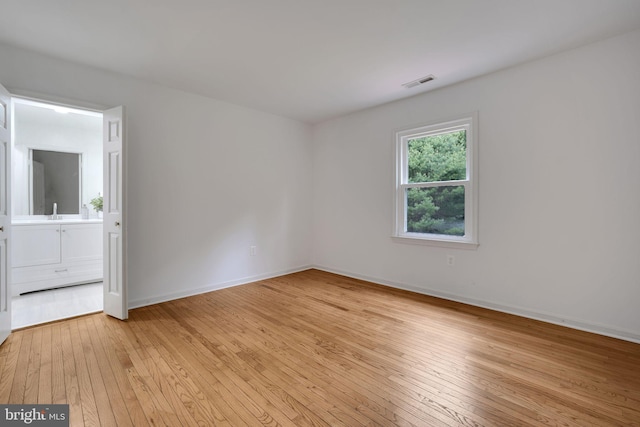 2407 Mare Ln, Oakton, VA 22124 - spare room with light wood-style flooring and baseboards