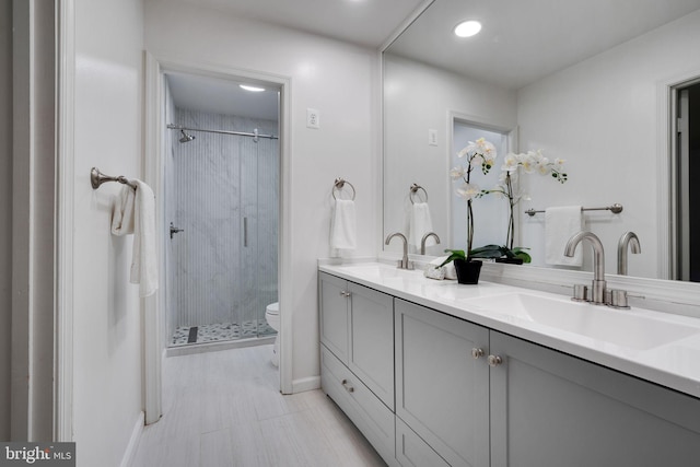 2407 Mare Ln, Oakton, VA 22124 - full bath featuring a stall shower, toilet, baseboards, double vanity, and recessed lighting