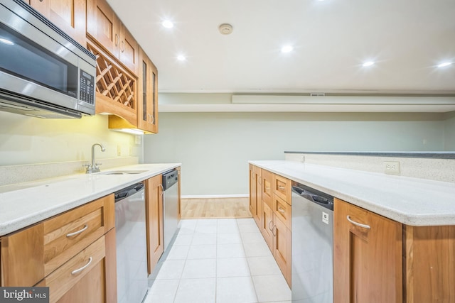 2407 Mare Ln, Oakton, VA 22124 - kitchen with stainless steel appliances, a sink, light countertops, brown cabinetry, and recessed lighting