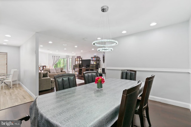 dining room with recessed lighting, a notable chandelier, wood finished floors, and baseboards