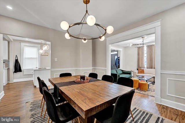 dining space featuring a chandelier and light wood-style floors